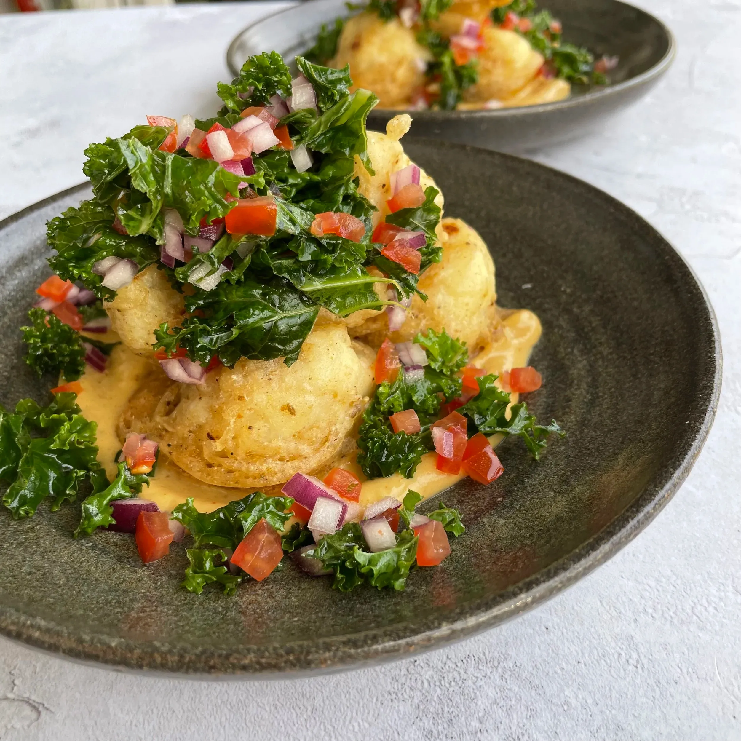 Deep-fried cauliflower with andrha curry sauce, kale salad